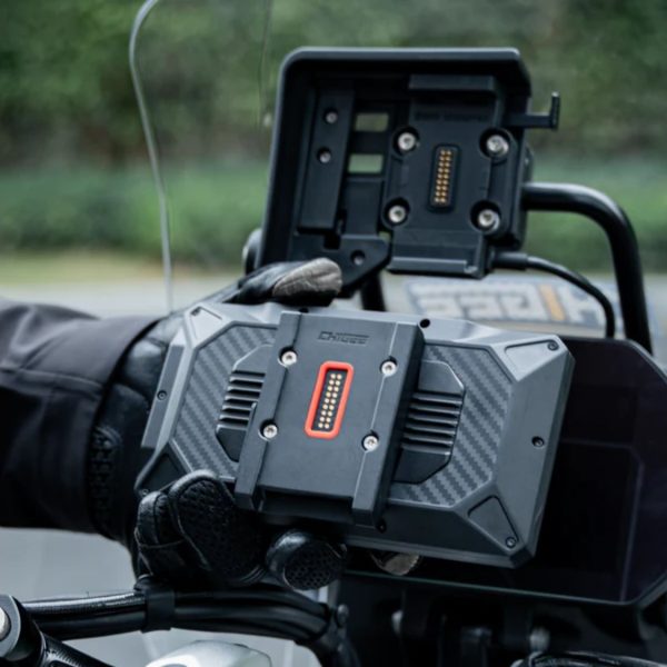 Rider removing Chigee AIO-6 display from BMW Quick-Release Module on adventure bike.